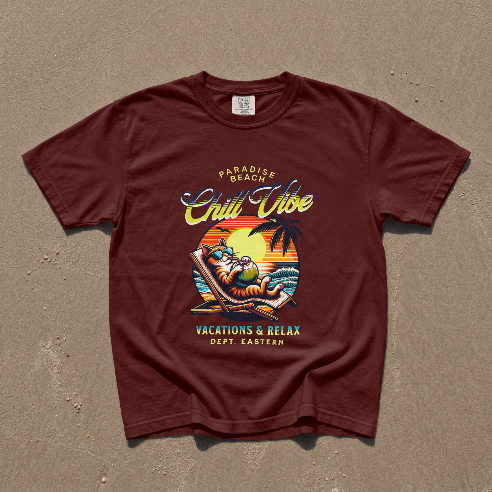 Model wearing a maroon premium cotton t-shirt with a bold retro Chill Vibe slogan and a funny lounging beach cat illustration