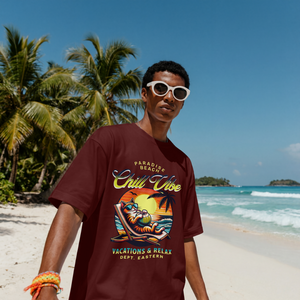 Model wearing a maroon premium cotton t-shirt with a bold retro Chill Vibe slogan and a funny lounging beach cat illustration