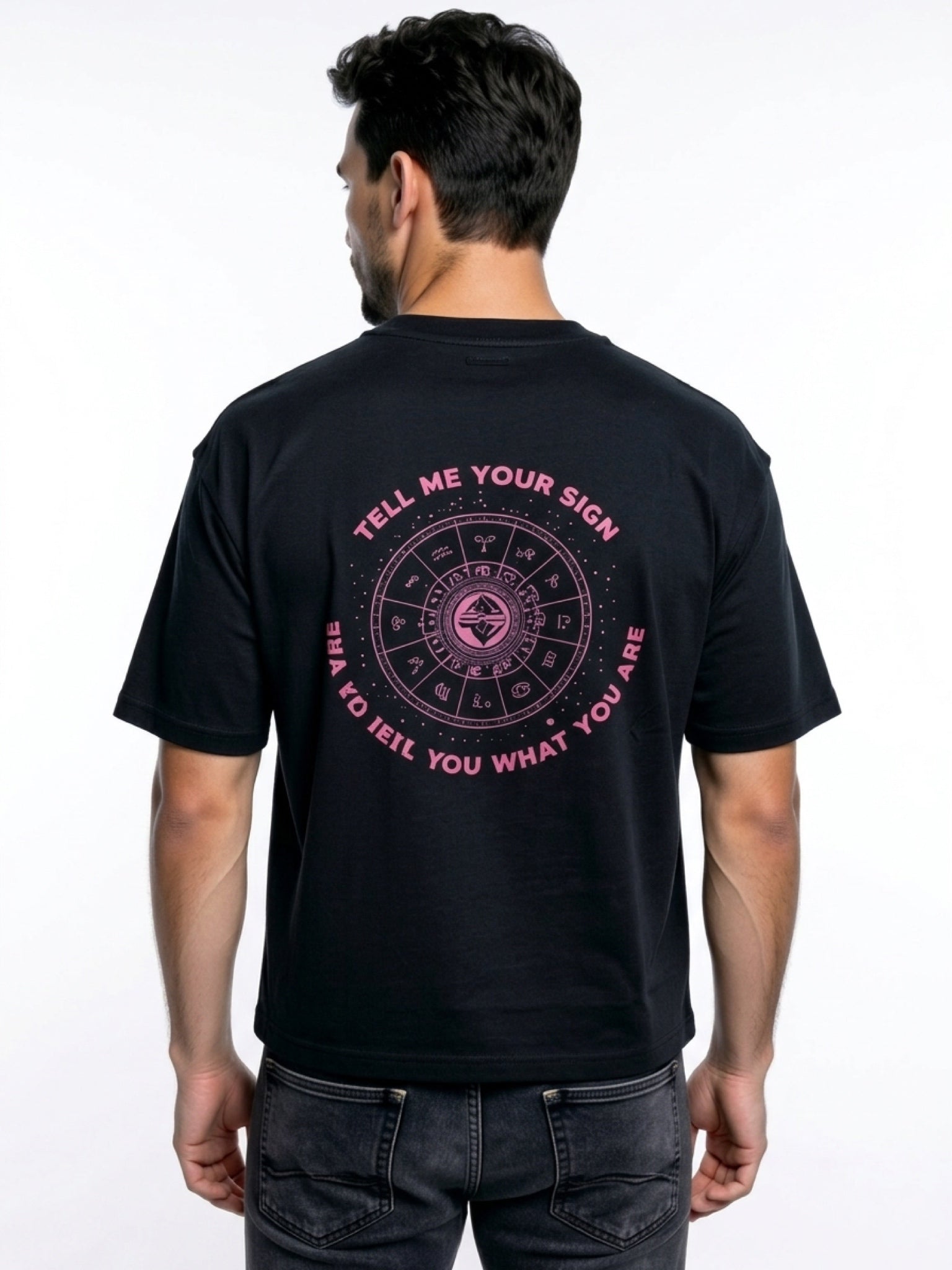 Model wearing a black premium t-shirt featuring a small pink Zodiac Sign slogan print on the chest