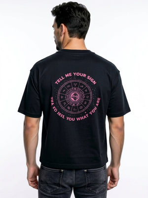 Model wearing a black premium t-shirt featuring a small pink Zodiac Sign slogan print on the chest