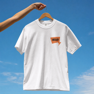 Front view of a premium cotton t-shirt with a small orange HELLO speech bubble badge printed on the left chest