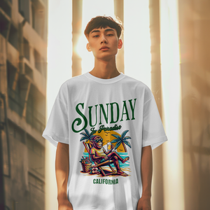 Model wearing a white relaxed fit t-shirt with a vintage green Sunday in Paradise slogan and a colorful beach sunset monkey graphic