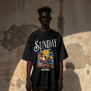 Model wearing a black premium cotton t-shirt with a vintage white Sunday in Paradise slogan and a colorful chilling beach monkey illustration