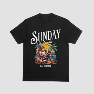 Model wearing a black premium cotton t-shirt with a vintage white Sunday in Paradise slogan and a colorful chilling beach monkey illustration
