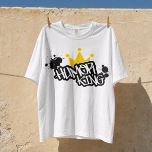 white relaxed fit streetwear t-shirt with a black paint splatter background, white Humor King typography, and a yellow crown