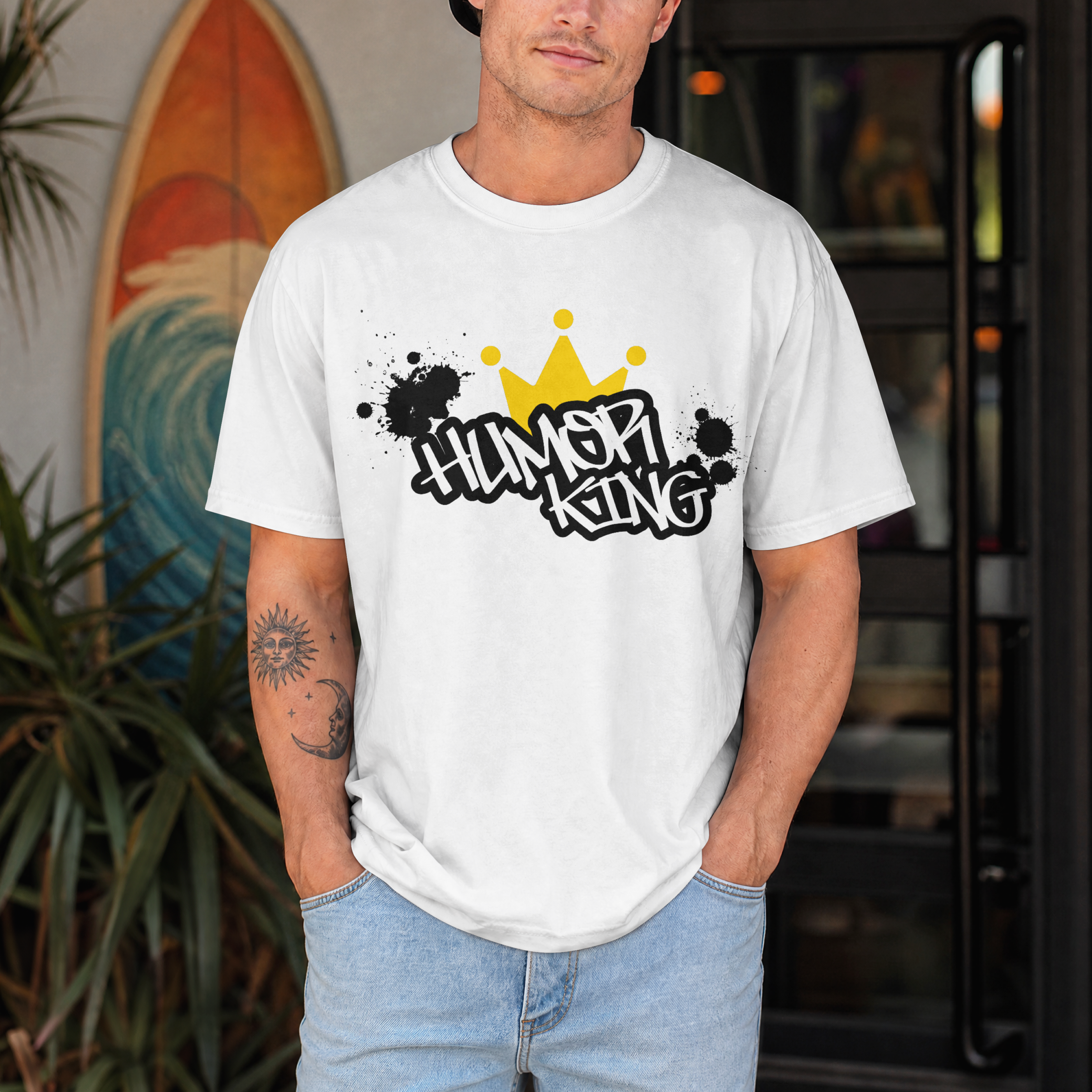 white relaxed fit streetwear t-shirt with a black paint splatter background, white Humor King typography, and a yellow crown